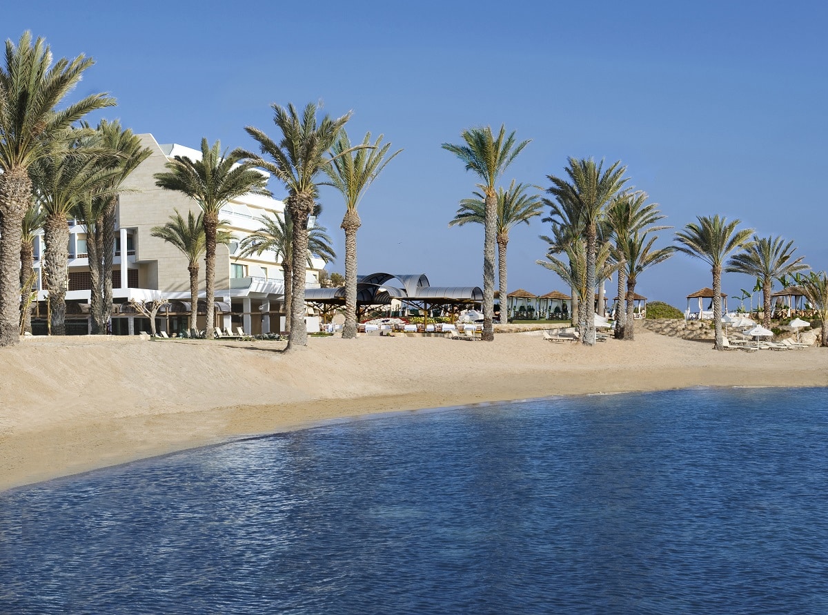 The sandy shore in front of Pioneer Beach Hotel by Constantinou Bros Hotels in the charming seaside of Paphos, Cyprus.